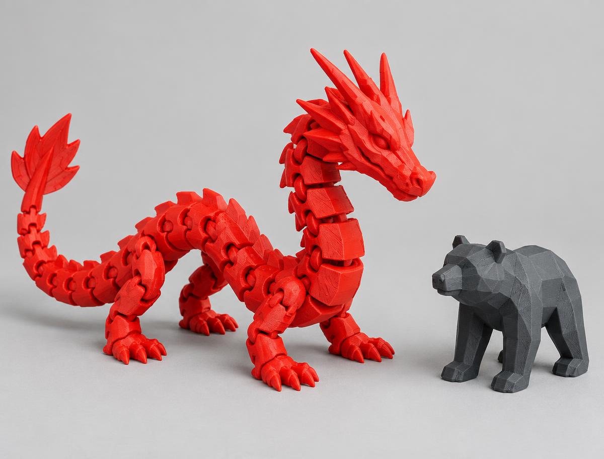 Red articulated dragon and graphite bear figurine